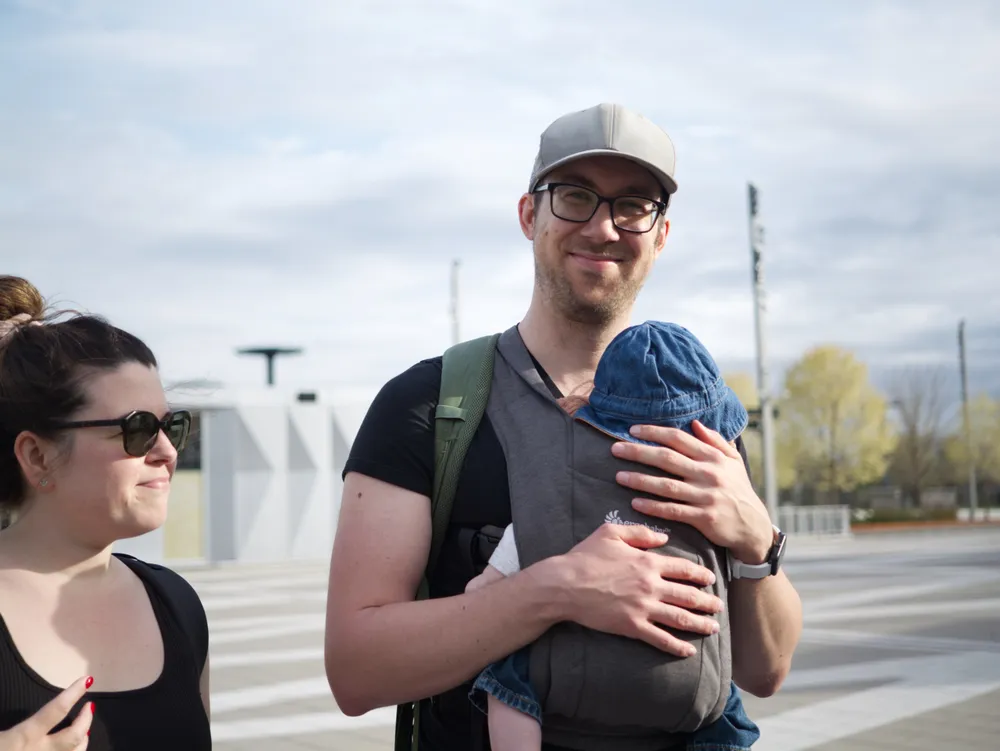 Patrick and Jasmine out with their baby in a carrier